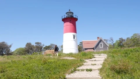 Girl walking at Lighthouse at Cape Cod Nauset Light Stock Footage 73515698