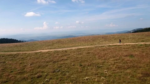Girl Walking Mountain Path, And Opens To A Beautiful View Of The Mountains Video stock 95736070