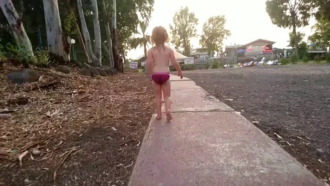 Girl walking on road wearing pink underware Stock Footage