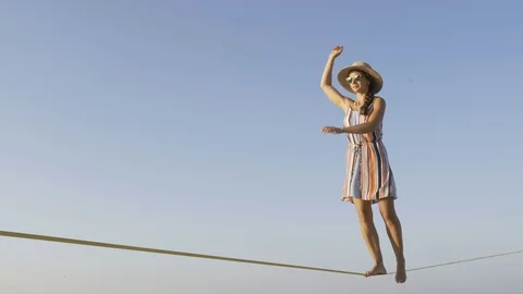 The girl is walking on the rope. Stock Footage 79499739