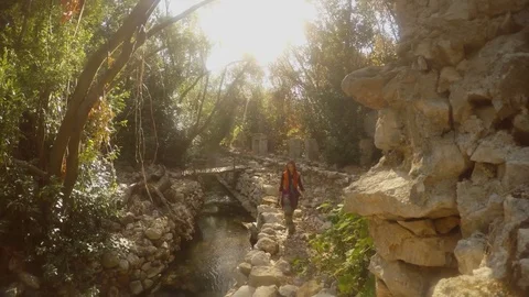 Girl is walking in ruins of two thousand-year-old city of Olympos, Lycia, Lycian Stock Footage 81745549