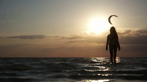Girl walking at sunset on sea Stock Footage