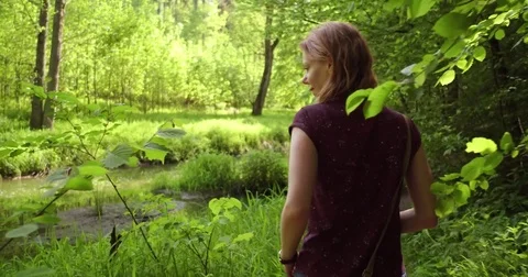 A girl walking through nature Stock Footage