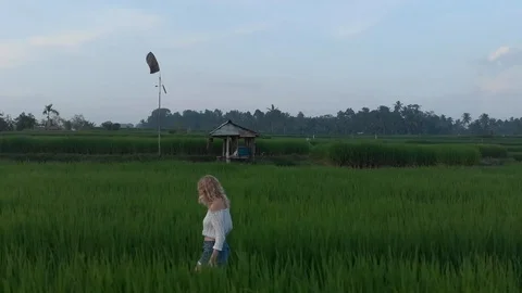 Girl walking through rice fields in Bali Stock Footage 107872064