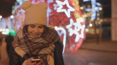 The girl walks around the city and talks on skype Stock Footage