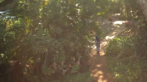 Girl walks down path Stock Footage 8688273