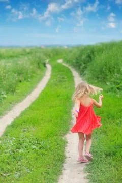 A girl walks in summer on a rural road Stock Photos