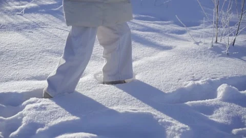 The girl walks through the deep snow. slow motion of snowdrift Stock Footage 234452937