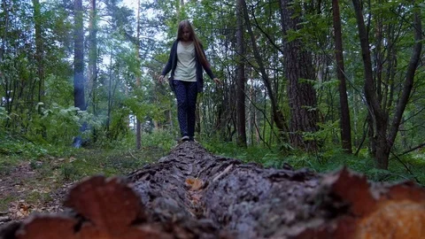 Girl walks on a timber Stock-Footage 80442912