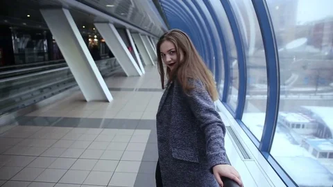 A girl walks by the windows Stock Footage 70147550