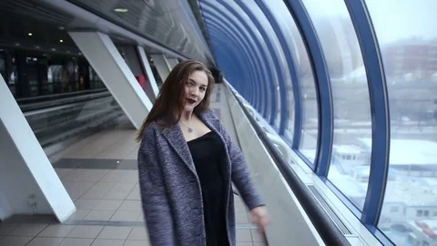 A girl walks by the windows Stock Footage 70147564