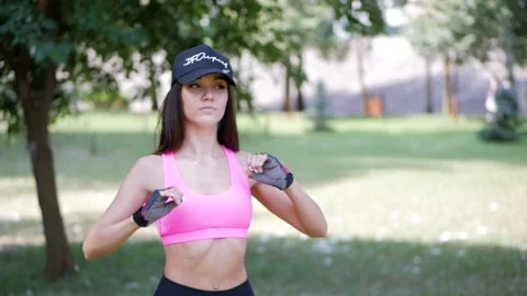 Girl warming up before exercise in park. Stock Footage 113735617