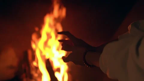 Girl warming her hands by the fireplace Stock-Footage 261040441