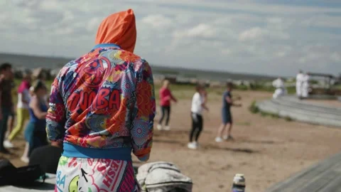 Girl warms up before Dancing flashmob on beach Stock Footage 159483861