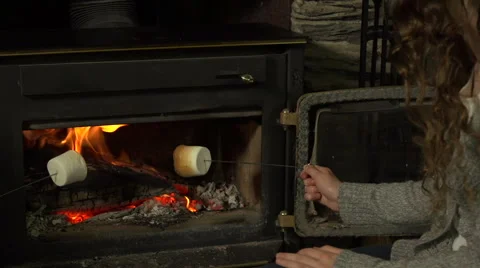 A girl warms marshmallows on a fire Stock Footage 44117641