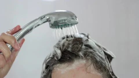 The girl washes off shampoo from the head close-up. Stock Footage 142074848