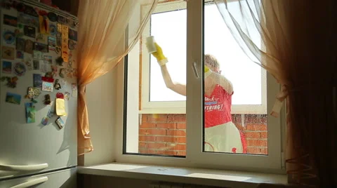 Girl washes the window, view from the front Stock Footage 42695075
