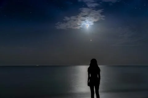 The girl is watching the eclipse of the moon Stock Photos