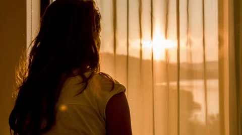 Girl watching through the window Stock Footage 65779599