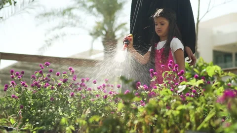 GIRL WATERING THE FLOWER Stock Footage