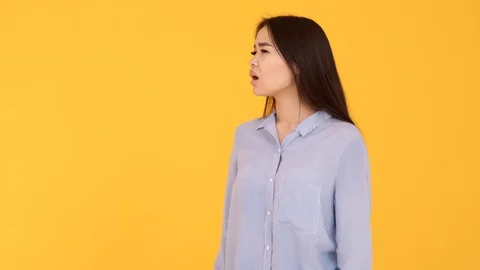 The girl waves her hands at camera. joy meeting . woman on yellow background Stock-Footage 125923554