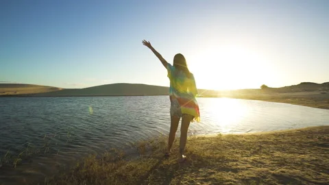 Girl waves at sunset in front of Dune Lake - Brazil Vidéo 152169732