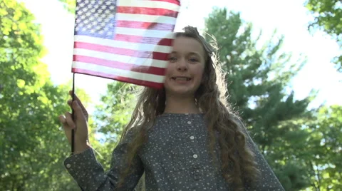 A girl waves a US flag Stock Footage 44117516
