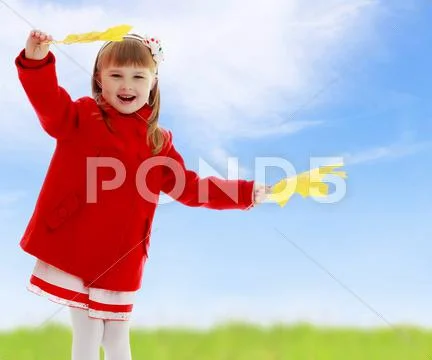 Girl waving maple leaves Stock Photos