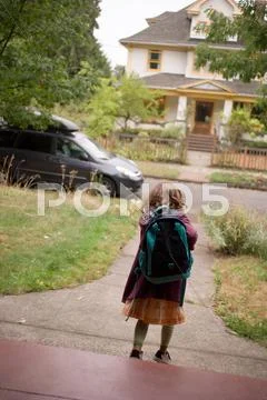 Girl Wearing Backpack Walking Down Path