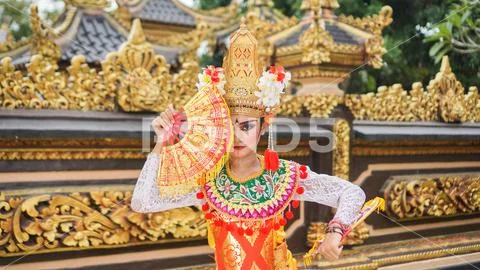 Girl wearing Balinese traditional dress with a dancing gesture on ...