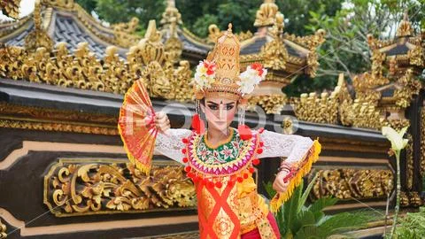 Girl wearing Balinese traditional dress with a dancing gesture on ...