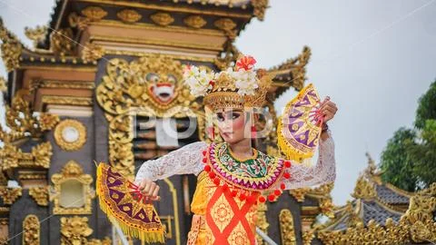 Girl wearing Balinese traditional dress with a dancing gesture on ...