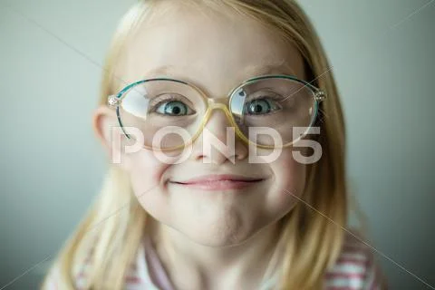 Girl wearing glasses making a silly face Stock Photos