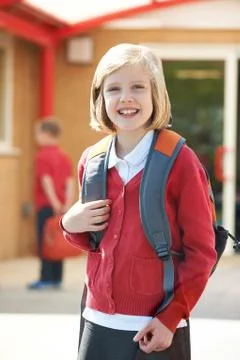 Girl Wearing School Uniform Standing In Playground Stock Photos