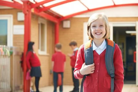 Girl Wearing Uniform Standing In School Playground Stock Photos