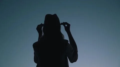 Girl wears a hat on the sky background Stock Footage 158122169