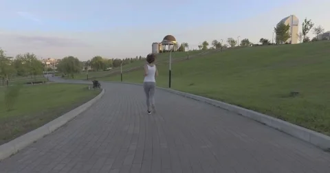 A girl while jogging in park Stock Footage 66504476