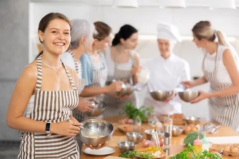 Girl while studying at culinary workshop, cooks appetizing sauce, marinade Stock Photos