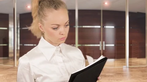 Girl in white blouse posing with documents in the business centre 스톡 동영상 78363527