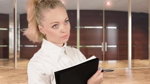 Girl in white blouse posing with documents in the business centre Stock Footage 78363610