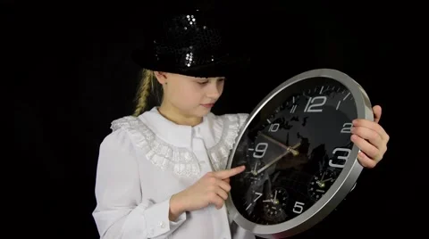 Girl in a white dress on a black background with the clock shows the time and Stock Footage 59447937