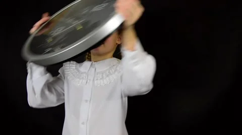 Girl in a white dress on a black background with the clock shows the time and Stock Footage 59458899