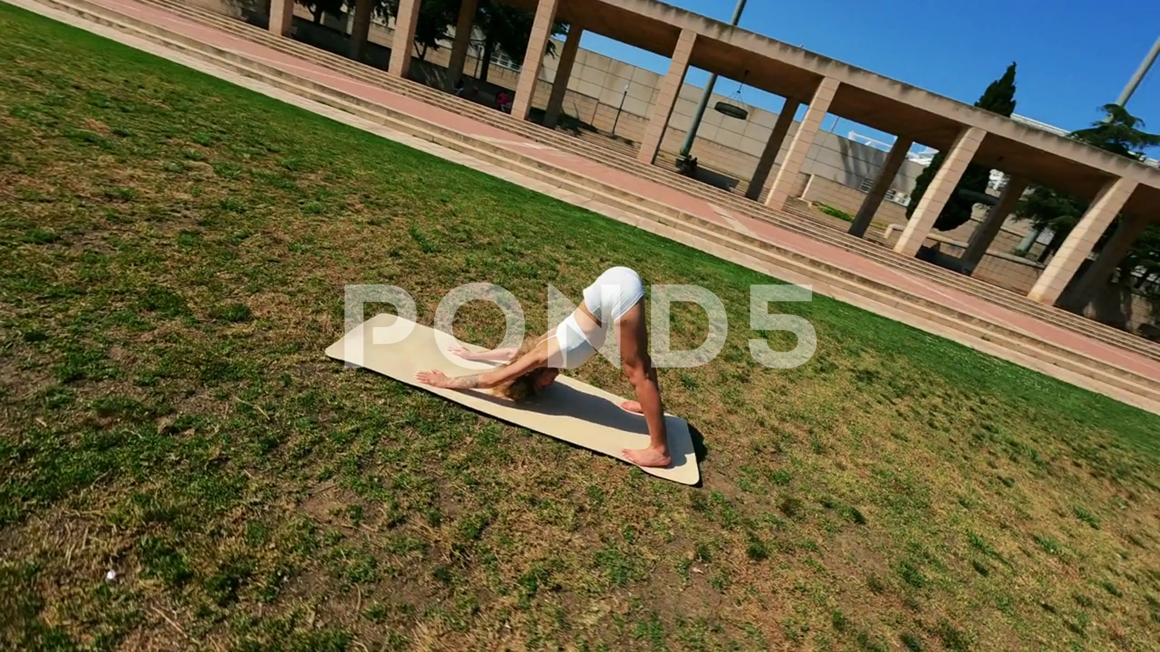 girl in white dress doing stretching exe, Stock Video