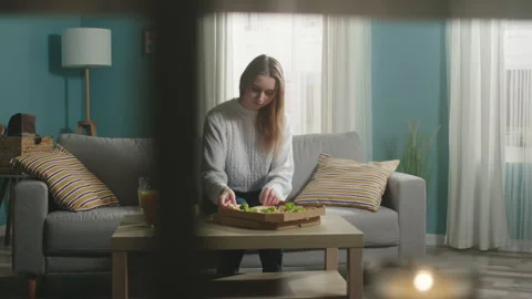Girl in a white jacket eats pizza Stock Footage 138222259