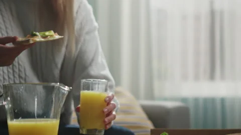 Girl in a white sweater eats a slice of Italian pizza Stock Footage 138221443