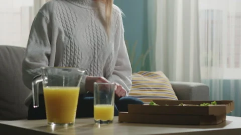 Girl in a white sweater eats a slice of Italian pizza Stock Footage 138222689