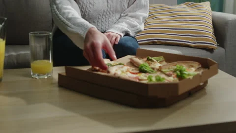 Girl in a white sweater eats a slice of Italian pizza Stock Footage 138222924