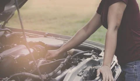 The girl who is checking the car engine Stock Photos
