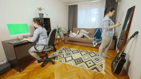 A girl who simultaneously works at a computer, reads a book and does makeup. Stock Footage 240620700