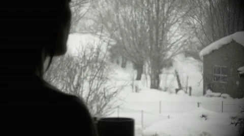Girl at window while snowing Video stock 46900153